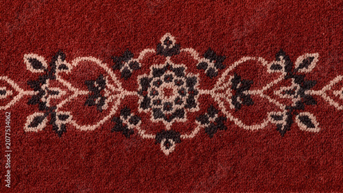 Close up high resolution texture of a traditional red Turkish woven carpet with intricate floral and geometric patterns
