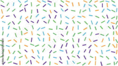 Fotografie Colorful confetti sprinkles pattern on white background festive celebration desi