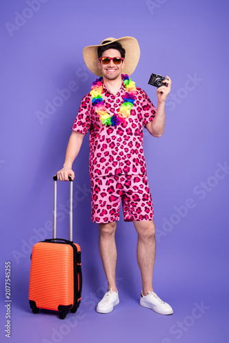 Fotografie Happy young man in colorful printed summer outfit with accessories enjoying vaca