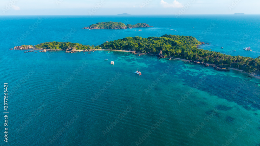 Obraz premium Aerial view of beautiful landscape, tourism boats, and people swimming on the sea and beach on Gam Ghi island in Phu Quoc, Kien Giang province, Vietnam