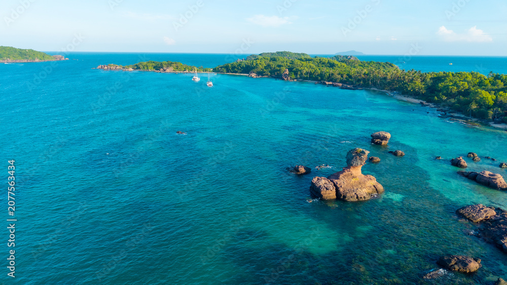 Obraz premium Aerial view of beautiful landscape, tourism boats, and people swimming on the sea and beach on Gam Ghi island in Phu Quoc, Kien Giang province, Vietnam