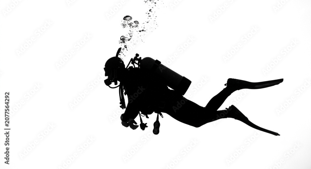 Fototapeta premium silhouette of a scuba diver exploring the ocean.
