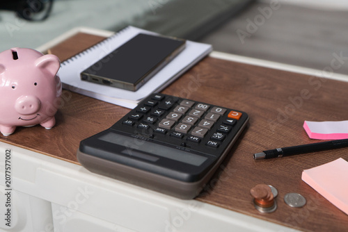 Business object of calculator and mobile phone to manage finances income, expenses tax deductions saving and instalment plans while carefully planning an accurate budget report.