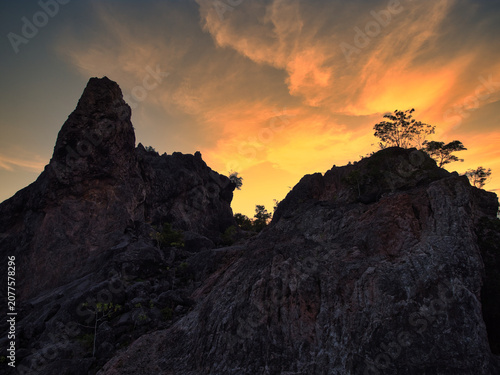 Canvastavla Limestone mountains at dawn, featuring a sharp and unique landscape with sparse vegetation set against a backdrop of sky and clouds in Surat Thani Province, Thailand