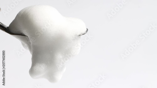 Cosmetic foam, bath foam sample close-up on a neutral background, front view.