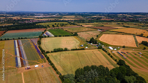 Wick flower fields aerial view with colorful striped petals and ferris wheel