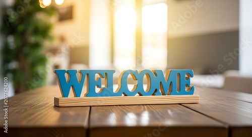 Blue welcome sign on wooden table in bright indoor setting
