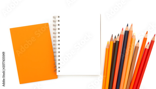 Design concept - Top view of orange spiral notebook and color pencil collection isolated on white background for mockup, Dreamy. White tone