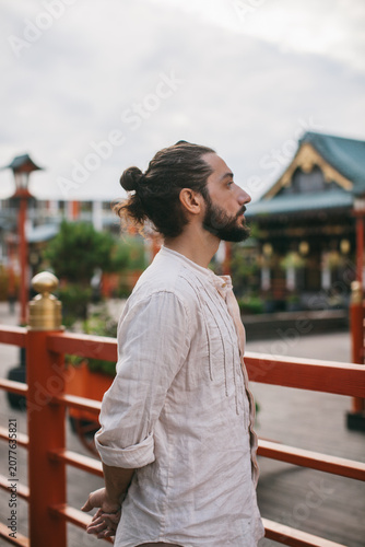 portrait of a man meditating standing on the street japan chinese background