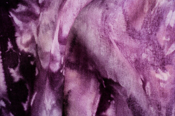 Macro view of purple tie dye fabric texture