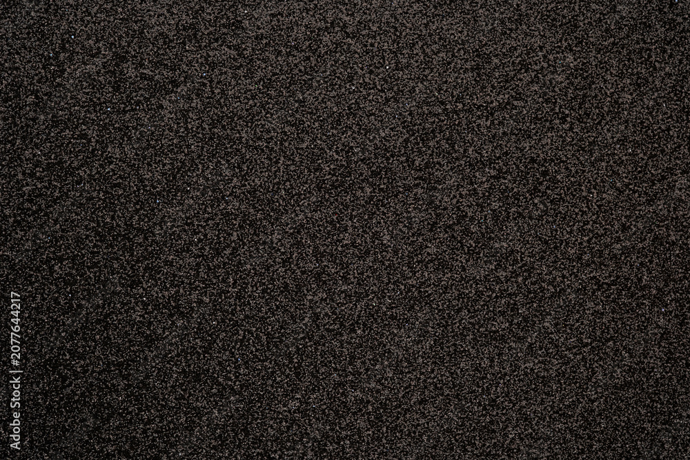 Fototapeta premium Close up of a dark textured surface with subtle glitter for background usage