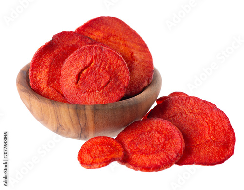 Crispy roasted carrot chips with sea salt, isolated on white background. Healthy and crunchy natural vegetable snack. Clipping path.