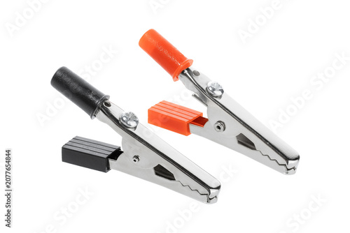 Silver colored alligator clamp with red and black insulator. Isolated on white.	
