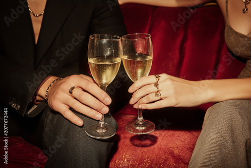 Hands Clinking Champagne Glasses Lounge Scene