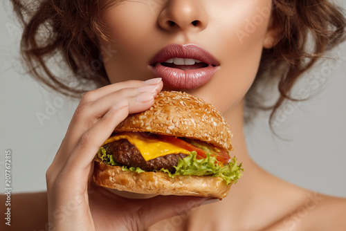 Woman Eating Hamburger Isolated Front View