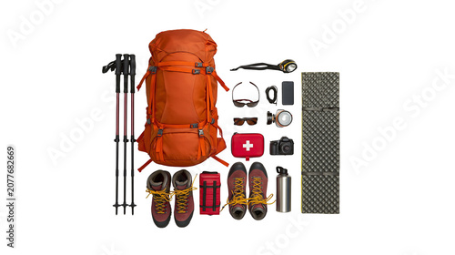 Fotografie Orange hiking backpack with trekking poles boots camera first aid kit, and sleep
