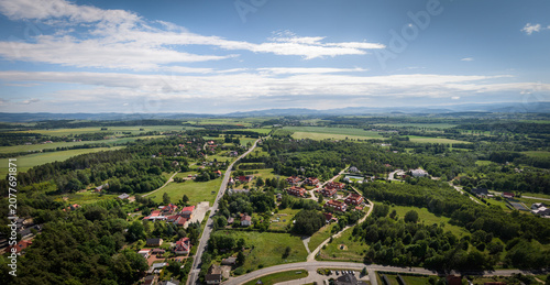 Panoramic aerial photograph of Polanica-Zdrój’s surroundings with the Sudety Mountains and Route 8, capturing a scenic travel photography perspective