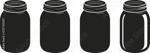 Four black cylindrical containers with silver ribbed tops, isolated on white background, jars lids de