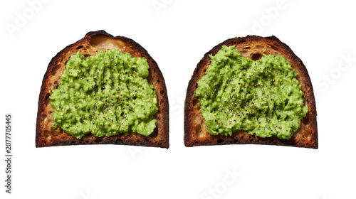 Photos Two slices of toasted sourdough bread with mashed avocado and black pepper