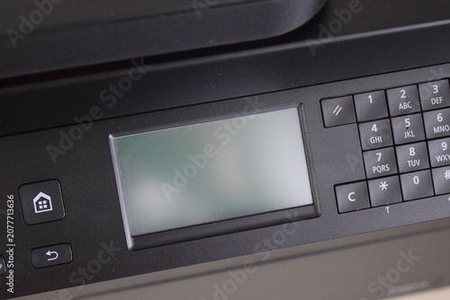 Control panel panel interface with LCD display and numbers keypad on modern multi function device 
