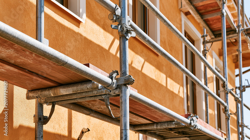 Construction scaffolding installed around residential building facade during exterior renovation and maintenance work