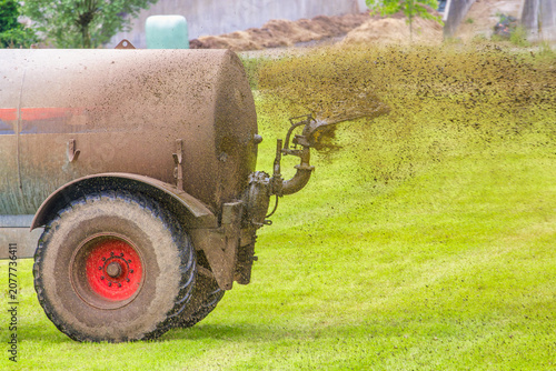 A Dutch farmer spreads manure on his grass fields