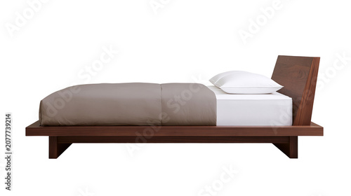 Fotografie Modern wooden platform bed with taupe duvet and white pillow