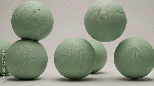 Minimalist Animation of Smooth Green Clay Spheres Bouncing and Merging