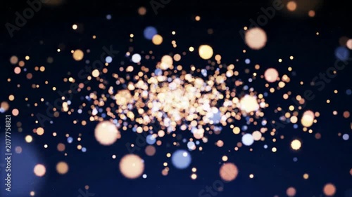 Abstract golden bokeh particles floating on dark blue background, magical light dust overlay for motion and cinematic transitions
