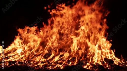 Intense bonfire flames burning at night, large campfire background, glowing orange fire pit, cinematic fire overlay for visual effects