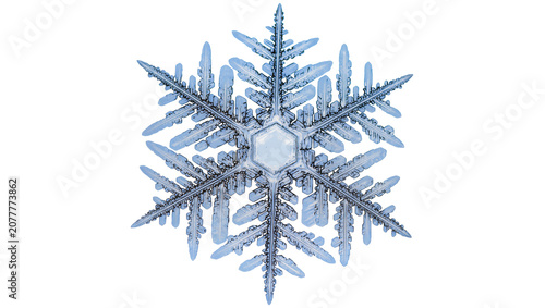 Intricate hexagonal ice crystal snowflake with delicate blue branches