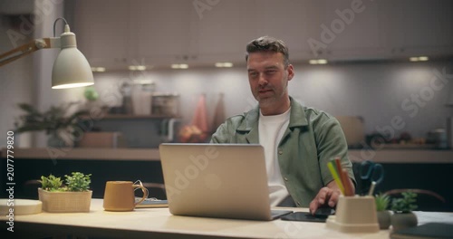 360 Degree. Caucasian Man Typing on Laptop Computer at Cozy Home Desk, Managing Online Calendar, Taking Notes and Organizing Schedule While Focused on Remote Work in Modern Apartment. Tracking Shot
