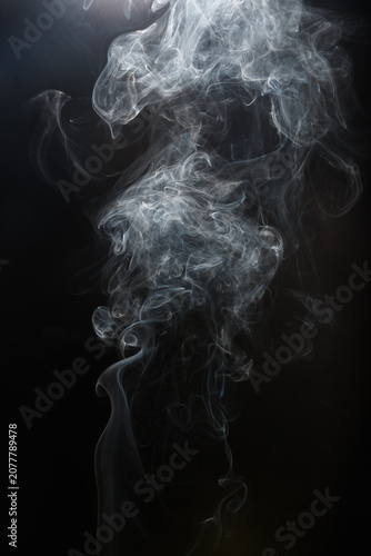 Shape  of white incense smoke  on black background