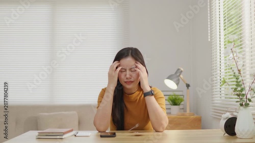 Woman frustrated with credit card debt throwing a card in stress, ideal for personal finance problems, overspending, money anxiety, budgeting and financial crisis concepts