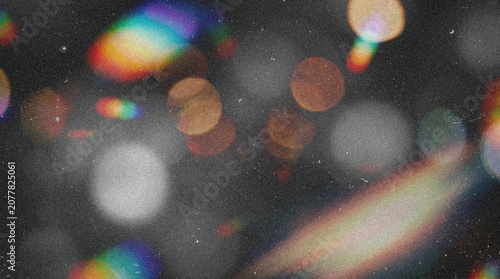 Abstract dark background overlay with retro analog film grain, grunge texture, damaged scratches and dust particles, featuring cinematic multicolor rainbow light leaks, glowing bokeh, and chromatic ab