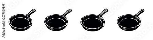 Foto Collection of four black cast iron skillets with handles on a white background