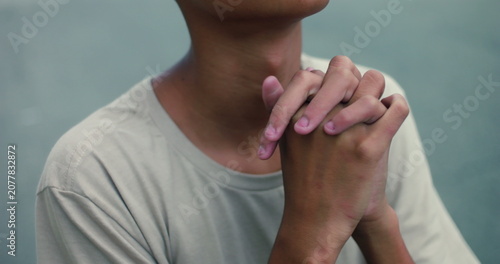 Quadro su tela Hispanic teenage boy of African descent praying with clasped hands looking up, d