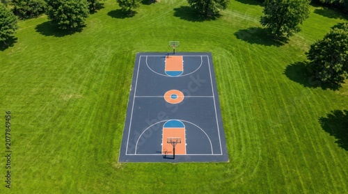 Aerial view of empty outdoor basketball court on green grass