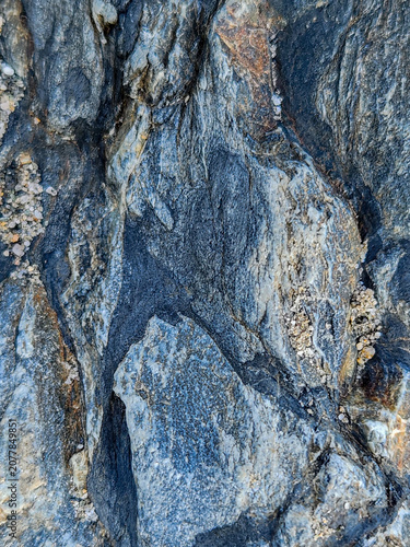Textured natural rock formation with blue and gray hues, background, texture