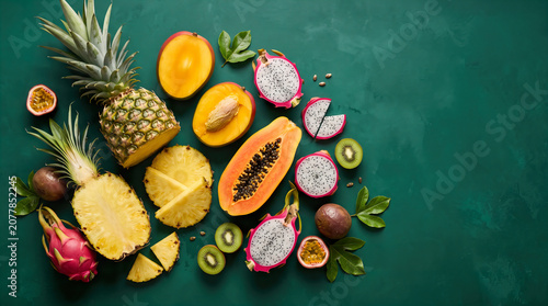 Organic Grocery Flat Lays Colorful Tropical Fruits on Dark Green Background