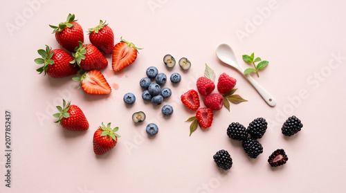 Organic Grocery Flat Lays Fresh Strawberries and Mixed Berries on Pink Background