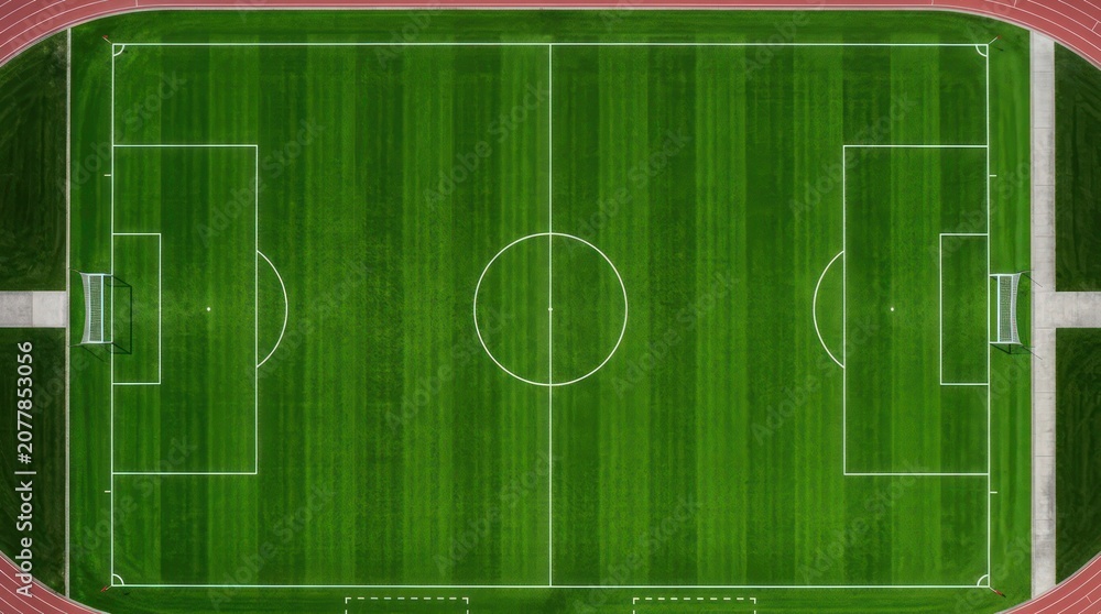 Obraz premium Top view of green soccer field with white markings