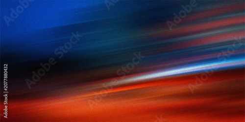 Fotografie Abstract dynamic light streaks with motion blur showing vivid colors of blue and orange against dark grainy textured film backdrop