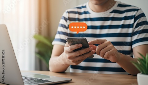 Person giving five star rating on mobile phone, showing customer satisfaction feedback.