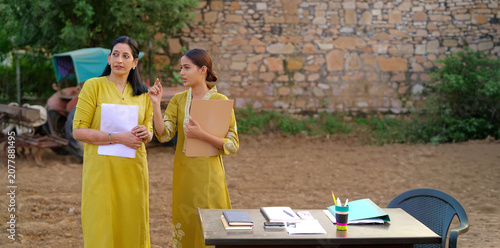 Konstfotografi Indian young adult gen z lady female hold files look talk share study learn plan new idea standing rural area