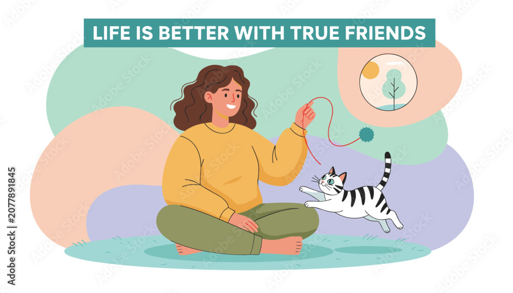 Obraz premium Smiling woman sitting comfortably on the grass and playing with her cat using a colorful toy string in a heartwarming and friendly scene.