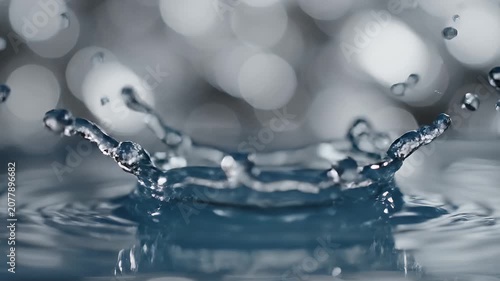 Macro photograph of a water splash creating a crown shape with tiny droplets frozen in motion