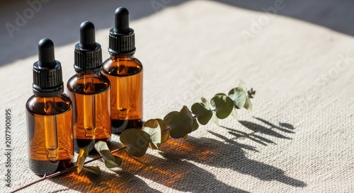 A clean composition of amber glass dropper bottles on raw linen, featuring soft sunlight shadows and a sprig of dried eucalyptus leaves, sustainable, aesthetic, clay