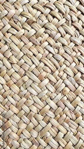 Close-up texture of a handwoven straw mat surface.