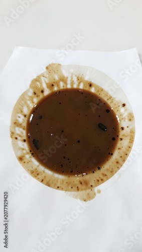 Stained white mug with remnants of a beverage.